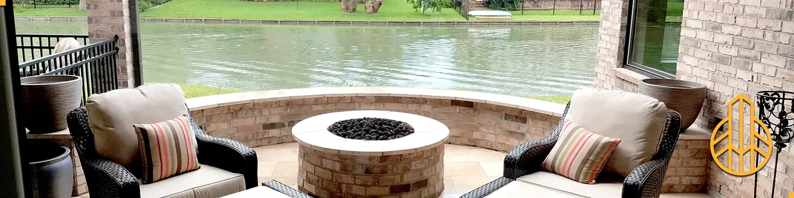 Hero Banner of a custom patio with tiled fire pit, walls, floors, and ledges on a Houston waterway